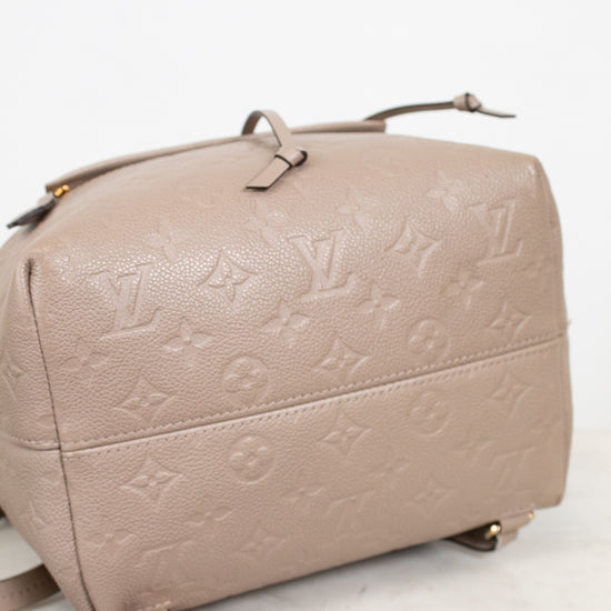 Beige handbag with monogram pattern on a white background