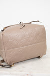 Beige handbag with monogram pattern on a white background