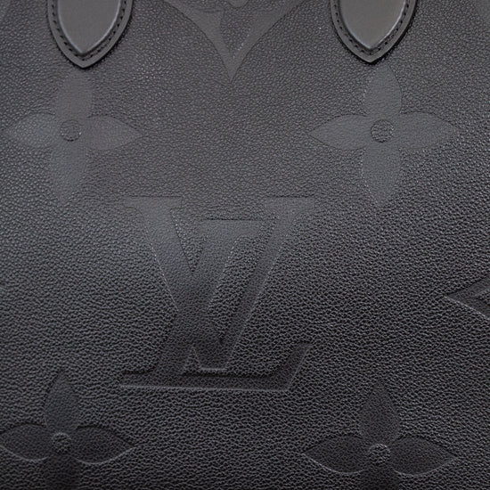 Black handbag with brand logo on a light background