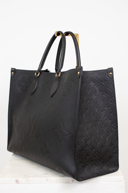 Black embossed handbag on a white background