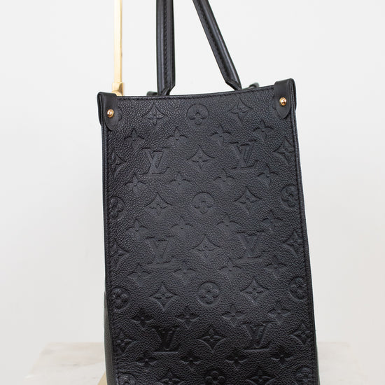 Black embossed handbag on a white background