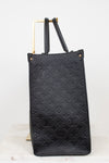 Black embossed handbag on a white background