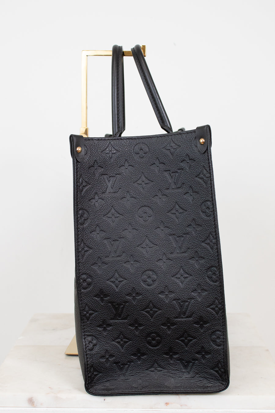 Black embossed handbag on a white background