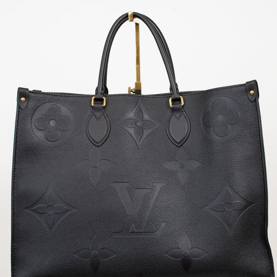 Black handbag with gold hardware on a white background