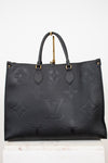 Black handbag with gold hardware on a white background