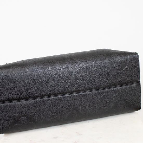 Bottom view of black bag with embossed logo on a white background