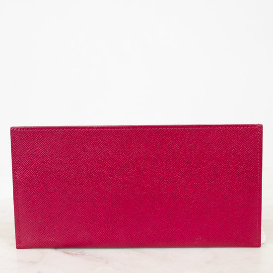 Pink wallet on a white marble surface