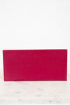 Pink wallet on a white marble surface