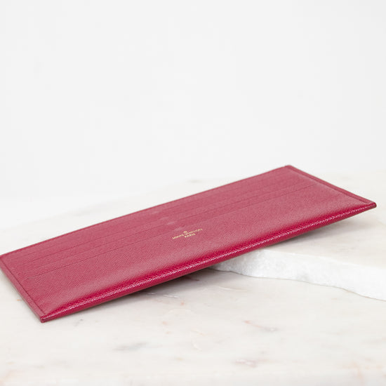 Pink wallet on a marble surface