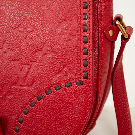 Red handbag with brand logo on a light background
