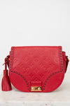 Red handbag with gold accents on a light gray background