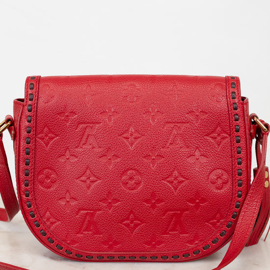 Red handbag with gold accents on a white background