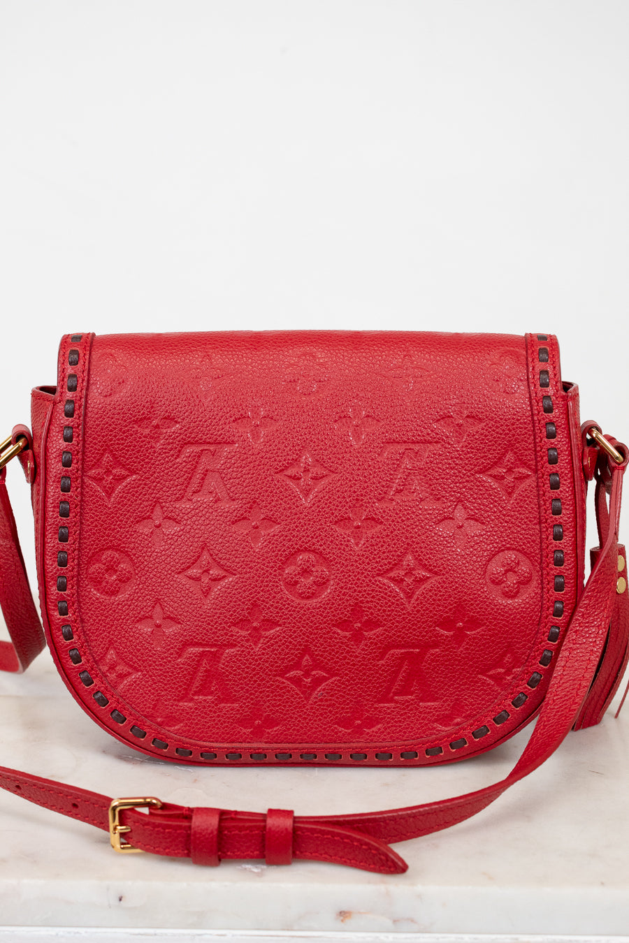 Red handbag with gold accents on a white background