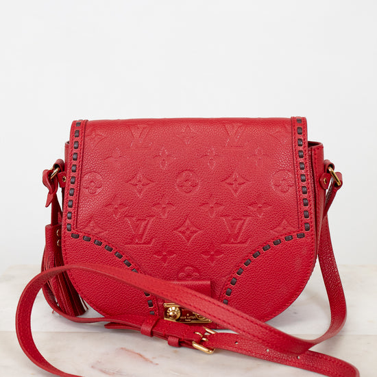 Red handbag with gold accents on a white background
