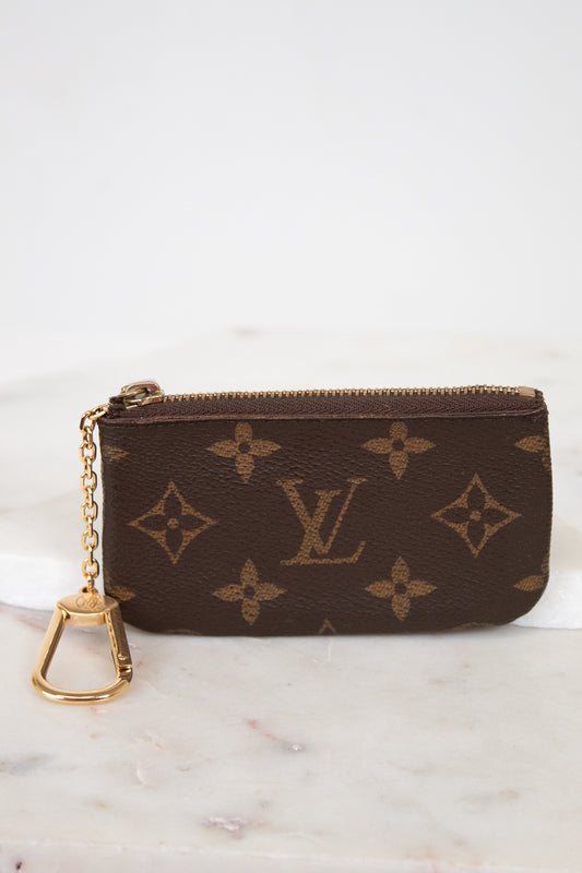 Louis Vuitton wallet with monogram pattern on a marble surface