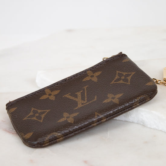 Louis Vuitton wallet with monogram pattern on a marble surface