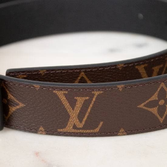 Louis Vuitton belt close up with monogram pattern on a marble surface