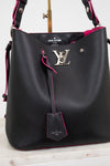 Louis Vuitton black pebbled leather hobo bag with bright pink lining and trim, featuring a silver-tone LV logo clasp and a hanging leather tag.