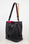 A black leather Louis Vuitton shoulder bag with a bright pink interior and pink contrast edges and lining, featuring a gold-tone metal stand on the strap and a silver-tone LV logo on the front.