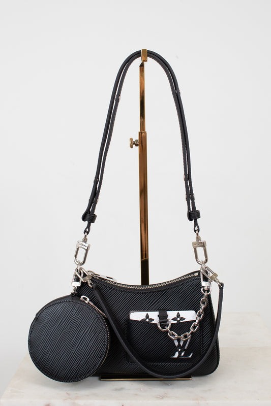 Black handbag with a matching round pouch on a light gray background