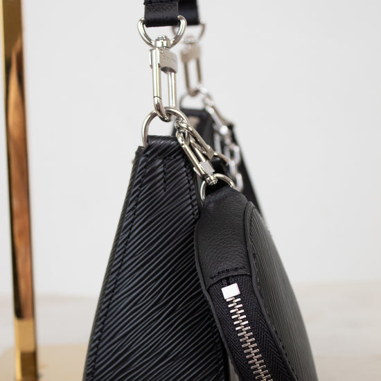Black leather pouch with zipper on a white surface