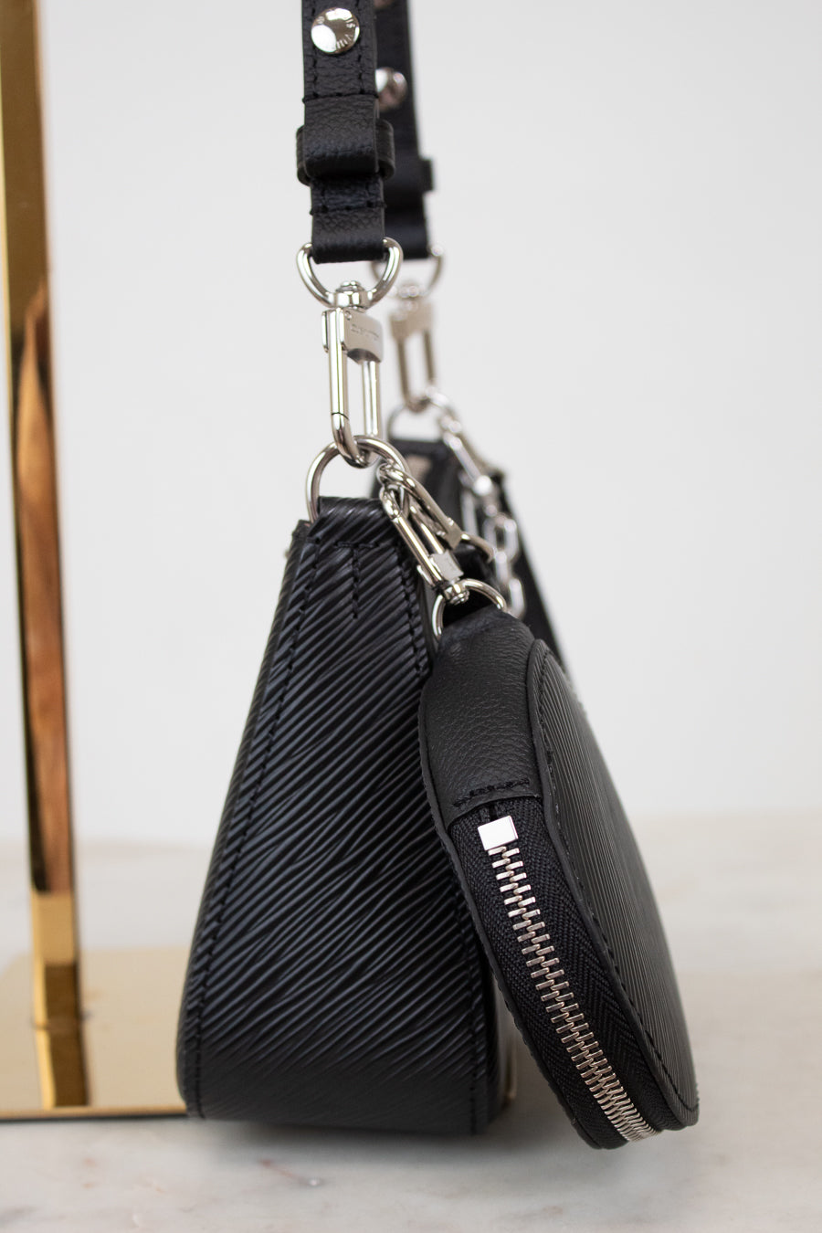 Black leather pouch with zipper on a white surface
