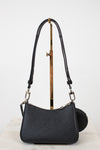 Black handbag with a strap on a white background