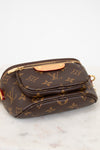 Brown Louis Vuitton handbag with monogram pattern on a white marble surface