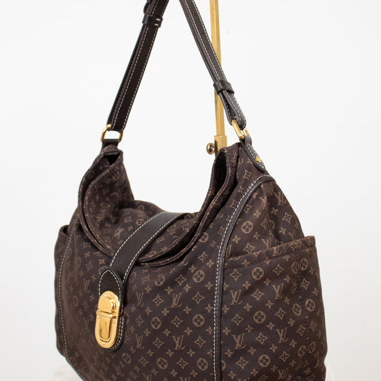 Brown handbag with gold accents on a white background