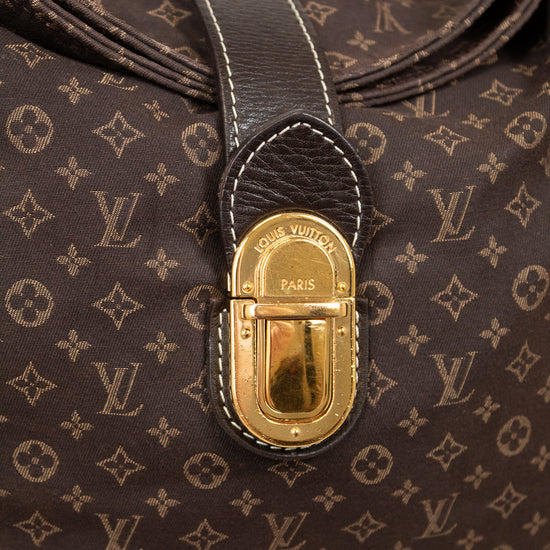 Close-up of a brown Louis Vuitton handbag with gold fastener on a light gray background