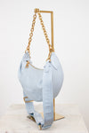 Light blue handbag with gold chain on a white background