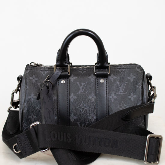 Black Louis Vuitton handbag with monogram pattern on a white background