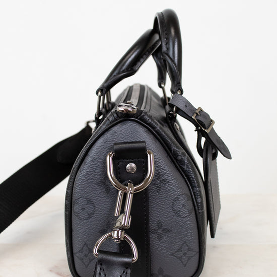 Black handbag with silver hardware on a white background