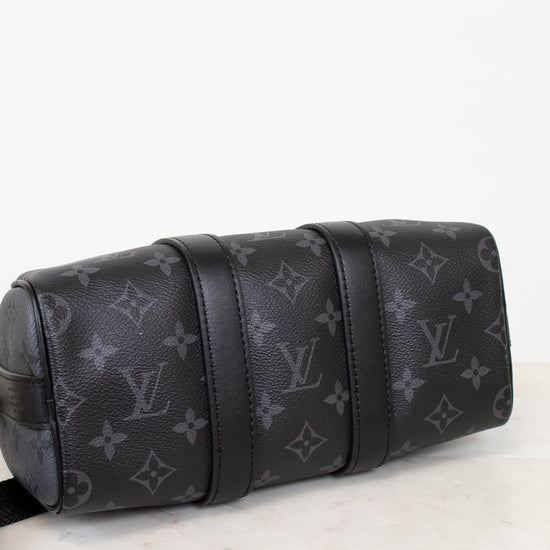 Black Louis Vuitton monogram bag on a white surface