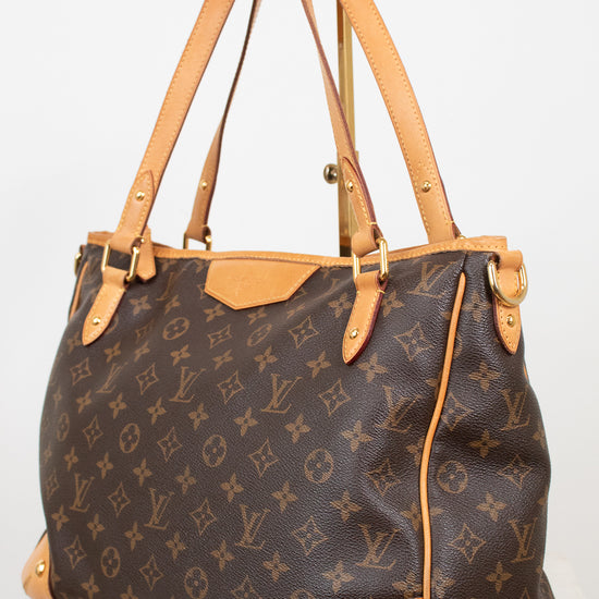 Louis Vuitton monogram canvas shoulder bag with tan leather trim and handles, displayed on a white background.