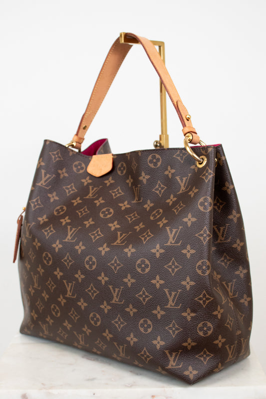 Designer handbag with monogram pattern on a white background