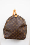 Side view of monogram coated canvas with leather trim details against a light background