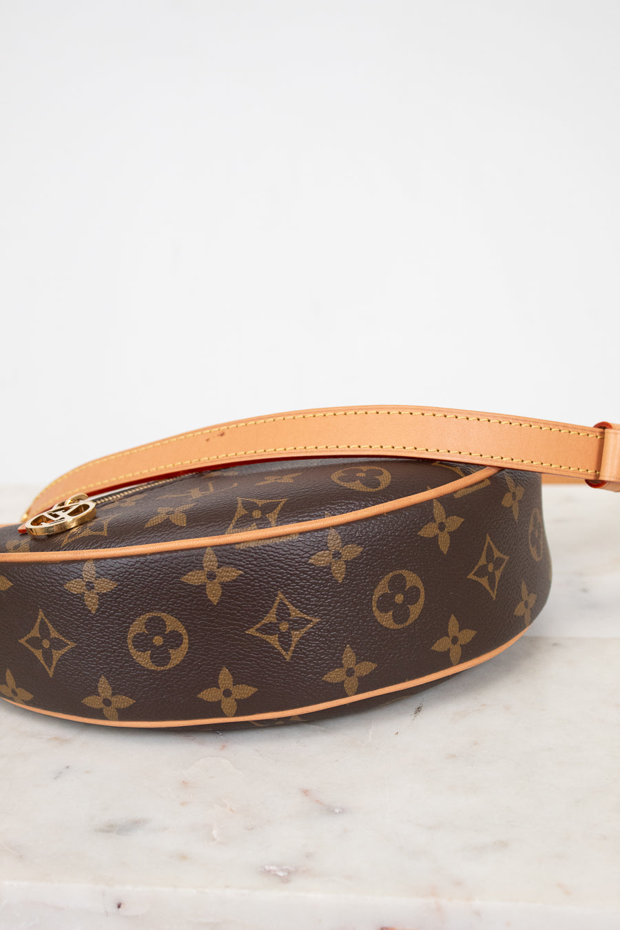Louis Vuitton monogram handbag on a marble surface