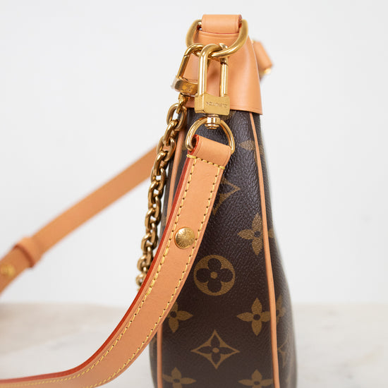 Louis Vuitton handbag with monogram pattern on a light background