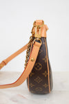 Louis Vuitton handbag with monogram pattern on a light background