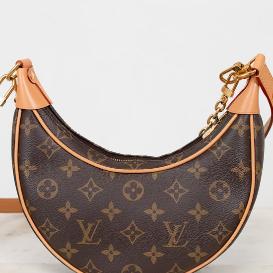 Louis Vuitton handbag with monogram pattern on a white background