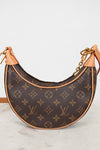 Louis Vuitton handbag with monogram pattern on a white background