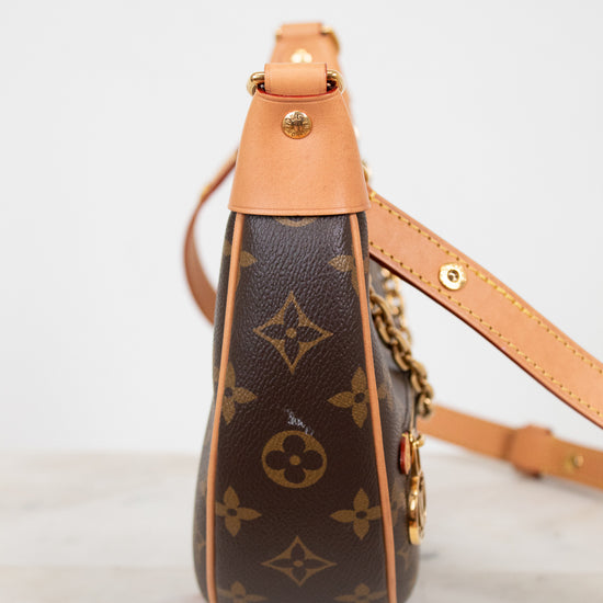 Louis Vuitton handbag with monogram pattern on a marble surface