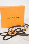 Louis Vuitton monogrammed leather star-shaped bag charm with a gold-tone LV logo medallion, shown with its signature orange Louis Vuitton box on a light marble surface.