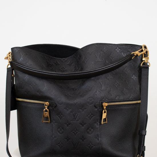 Black handbag with gold accents on a white background