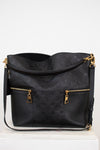 Black handbag with gold accents on a white background