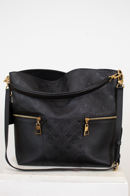Black handbag with gold accents on a white background