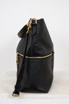 Black leather backpack with gold zippers on a white background