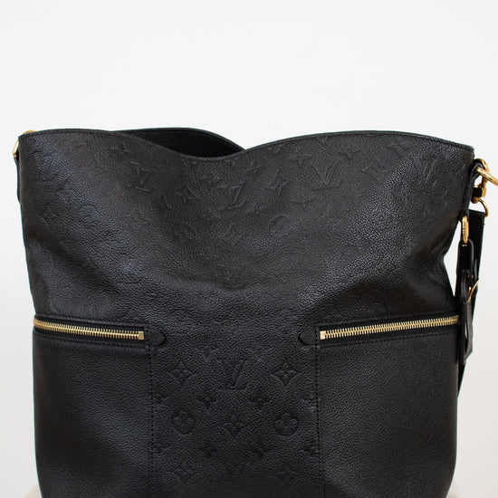 Black handbag with gold accents on a white background