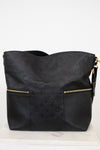 Black handbag with gold accents on a white background